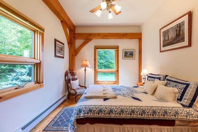 bedroom with light wood-type flooring and baseboard heating