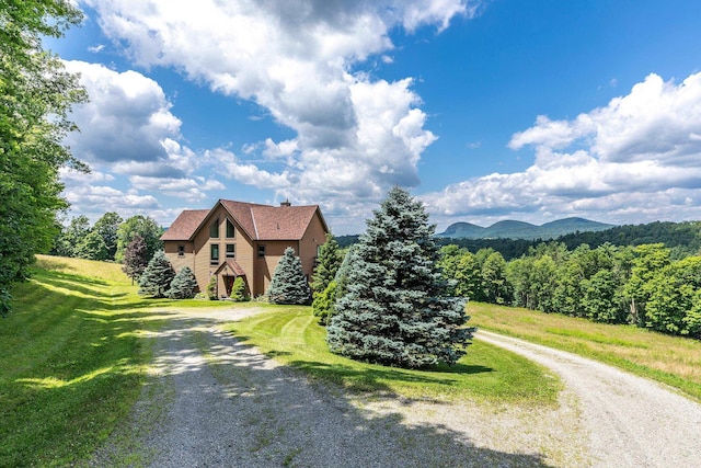 view of front of house featuring a mountain view and a front yard