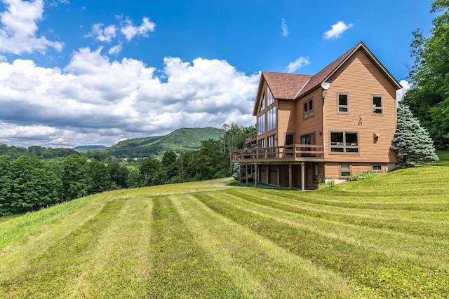 view of yard featuring a deck with mountain view