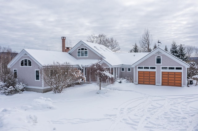 view of front of house featuring a garage and a chimney