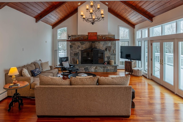 living area featuring a chandelier, beamed ceiling, and wooden ceiling