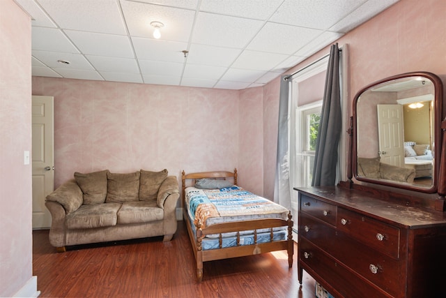 bedroom with hardwood / wood-style flooring and a paneled ceiling