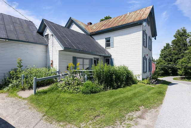 view of home's exterior with a yard