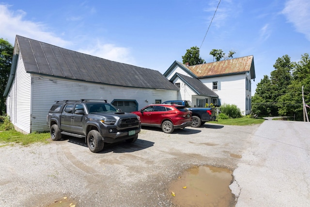 view of vehicle parking with a garage