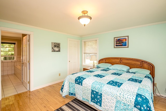 bedroom featuring ornamental molding and light wood-type flooring