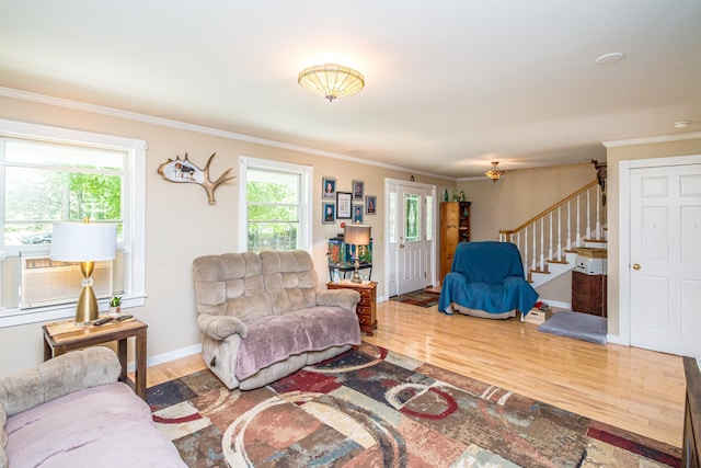 living room featuring cooling unit, crown molding, and wood-type flooring