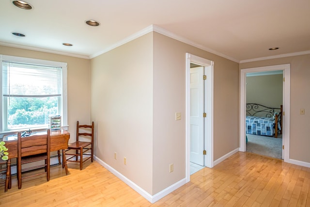 office area with ornamental molding and light hardwood / wood-style floors