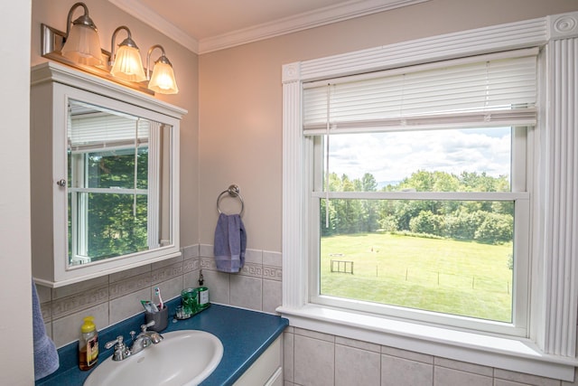 bathroom featuring vanity, ornamental molding, and tile walls