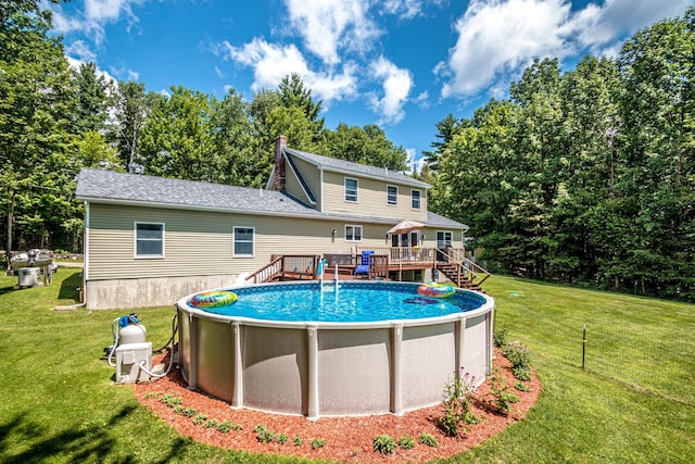 back of house featuring a yard and a swimming pool side deck