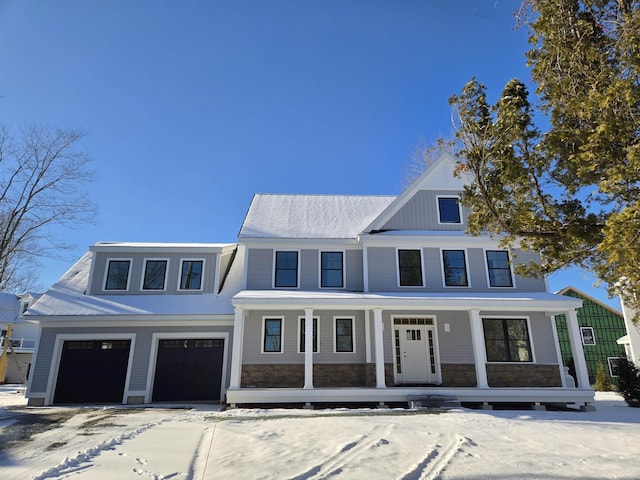 view of front of property featuring covered porch and a garage