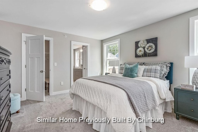 bedroom with light colored carpet and connected bathroom