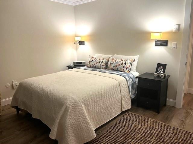 bedroom featuring crown molding and hardwood / wood-style floors