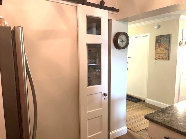 corridor featuring hardwood / wood-style flooring and crown molding