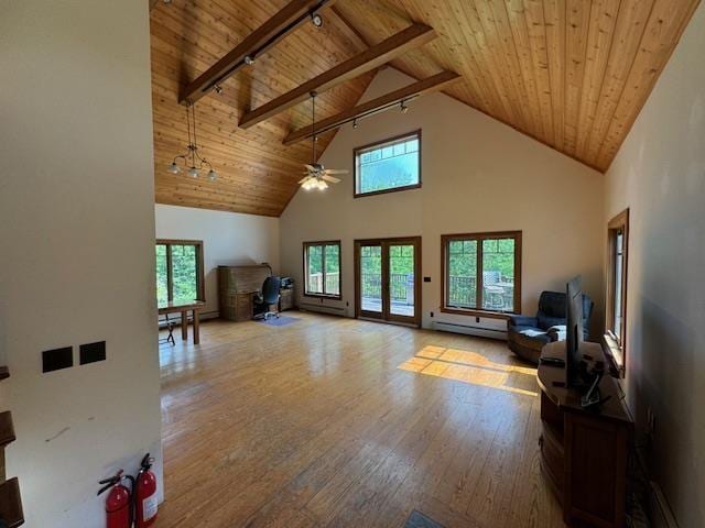 living room featuring plenty of natural light, wood ceiling, beam ceiling, and hardwood / wood-style floors