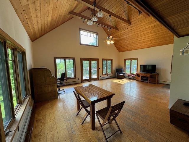 dining space featuring plenty of natural light, wood-type flooring, and wooden ceiling