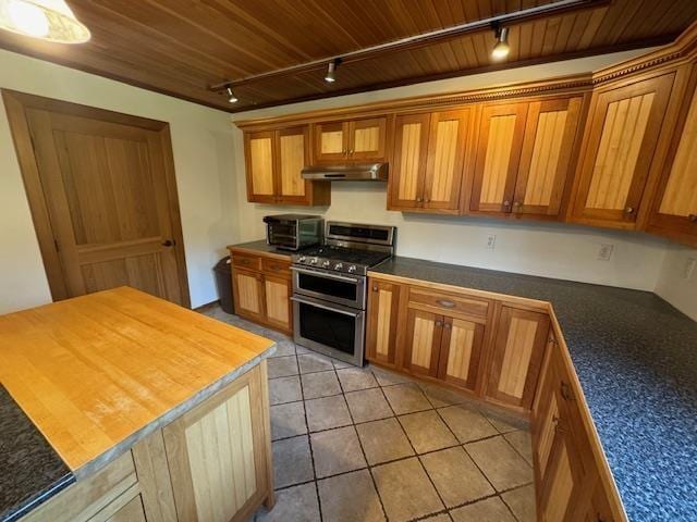 kitchen with range with two ovens, wooden ceiling, brown cabinets, and under cabinet range hood