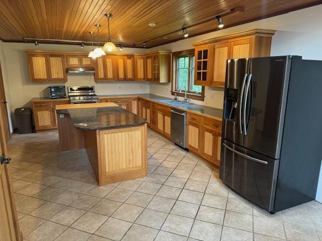 kitchen featuring under cabinet range hood, a kitchen island, a sink, wood ceiling, and appliances with stainless steel finishes