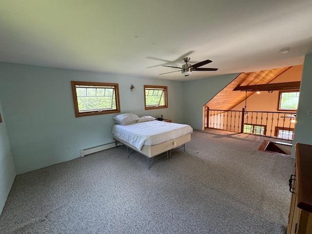 carpeted bedroom with lofted ceiling