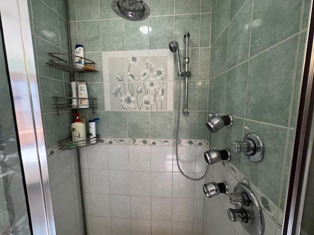 full bath with a tile shower