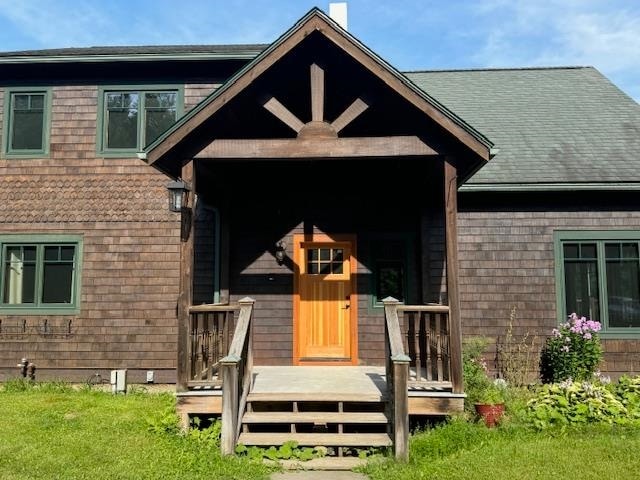 rear view of property featuring a porch