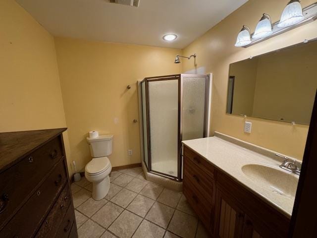 bathroom with a stall shower, baseboards, toilet, tile patterned floors, and vanity