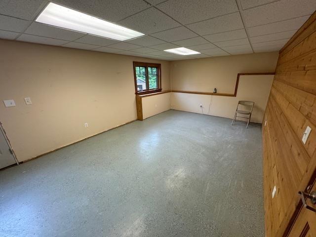 basement with a paneled ceiling