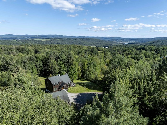 drone / aerial view featuring a mountain view and a forest view