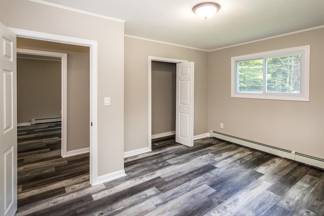 unfurnished bedroom with crown molding, dark hardwood / wood-style floors, baseboard heating, and a closet