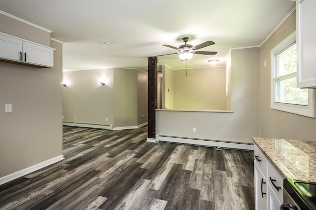 empty room with crown molding, a baseboard heating unit, ceiling fan, and dark hardwood / wood-style floors