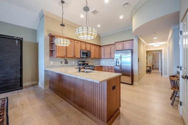 kitchen with stainless steel appliances, visible vents, ornamental molding, and a peninsula