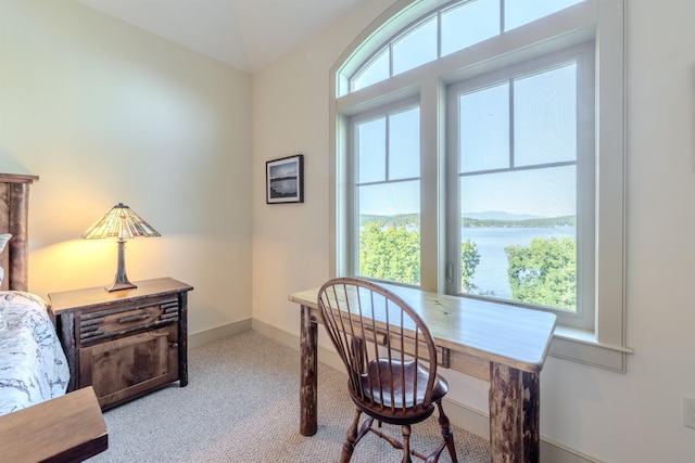 home office featuring carpet, a water view, and baseboards