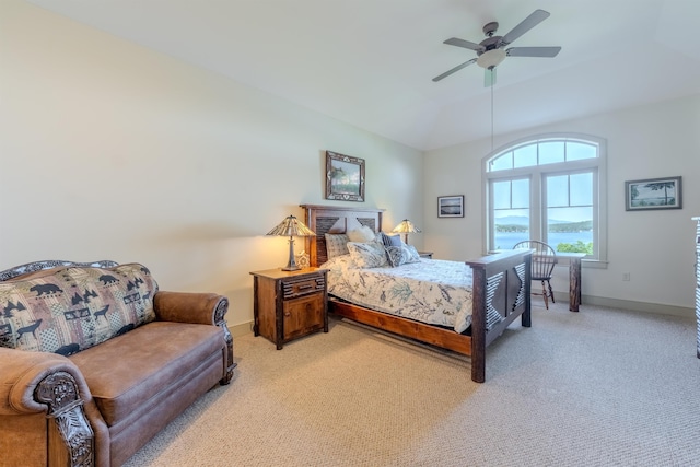 bedroom featuring a ceiling fan, light colored carpet, and baseboards