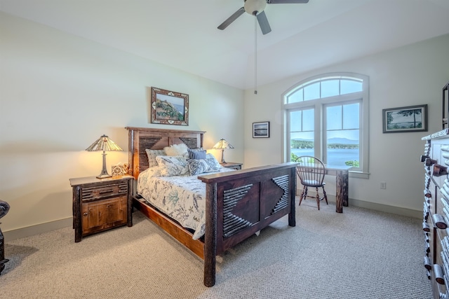 bedroom featuring carpet floors, a water view, ceiling fan, and baseboards