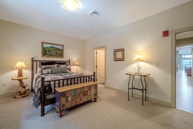 bedroom with carpet, visible vents, and baseboards