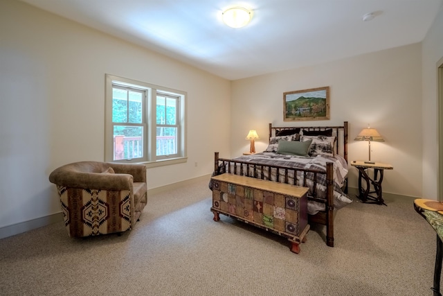 carpeted bedroom featuring baseboards