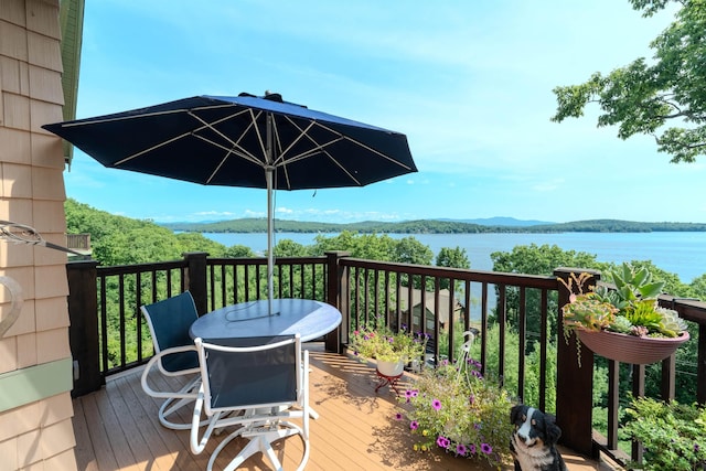 wooden terrace featuring a water view