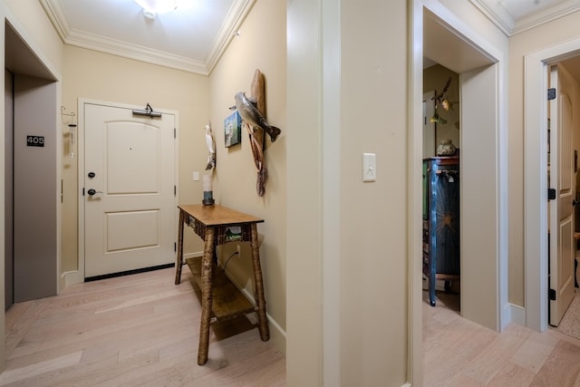 interior space with light wood finished floors, ornamental molding, and baseboards