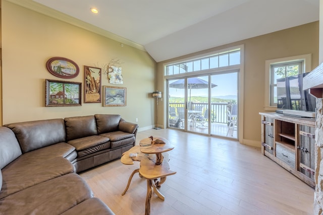 living room with vaulted ceiling, light wood-style flooring, and baseboards