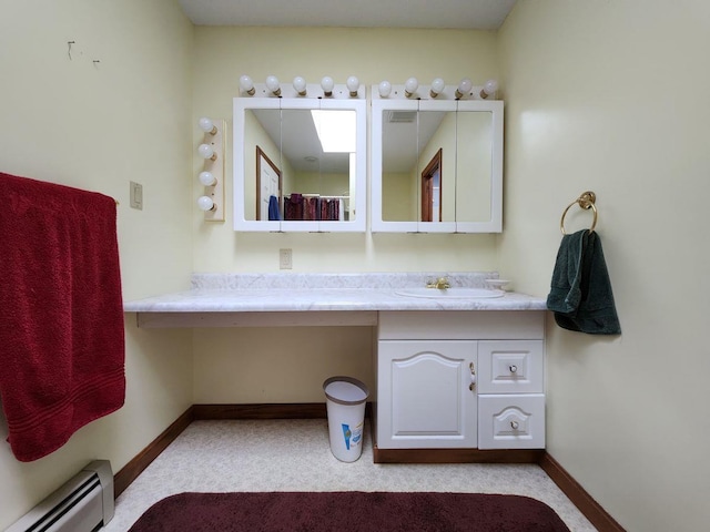 bathroom with a baseboard heating unit and vanity