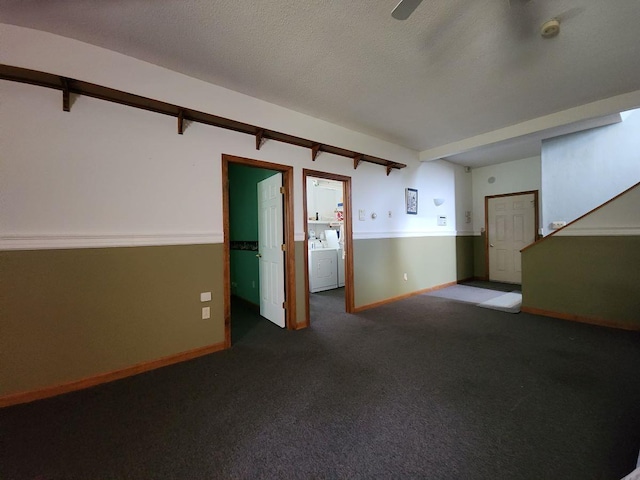 spare room with washing machine and clothes dryer, carpet, and a textured ceiling