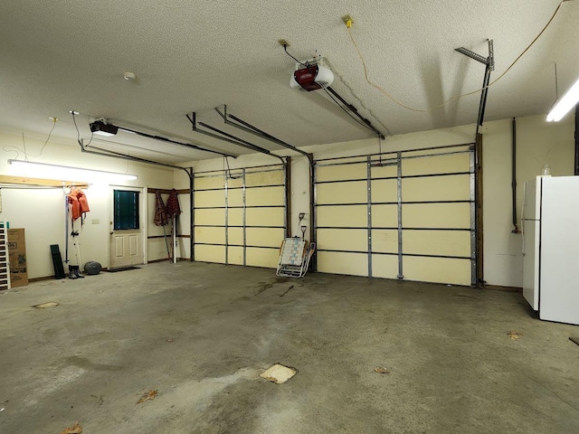 garage featuring a garage door opener and white refrigerator