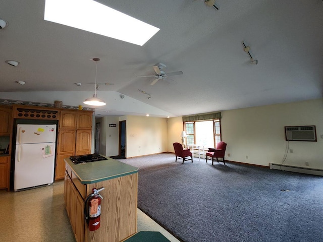 kitchen with black gas cooktop, a center island, a wall unit AC, white refrigerator, and baseboard heating