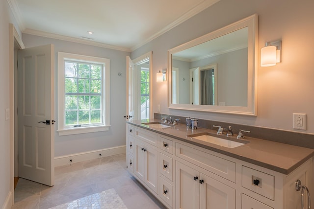 bathroom featuring double vanity, ornamental molding, a sink, and baseboards