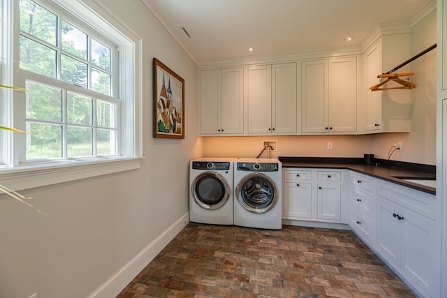 laundry room featuring crown molding, recessed lighting, baseboards, cabinet space, and washer and dryer