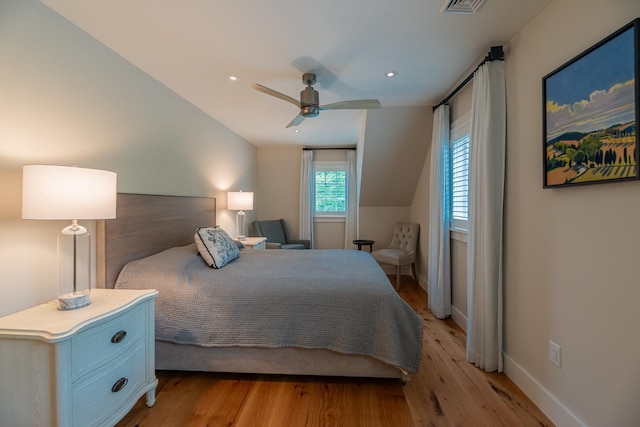 bedroom featuring ceiling fan, baseboards, lofted ceiling, and light wood-type flooring
