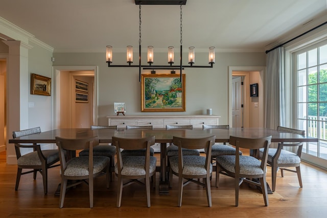 dining room with ornamental molding, breakfast area, and light wood finished floors