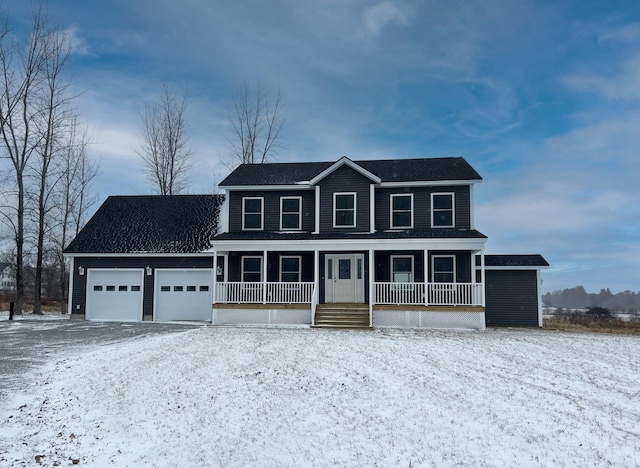 colonial house featuring a garage and covered porch