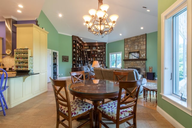 dining room featuring a fireplace and a chandelier