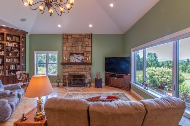 living room with an inviting chandelier, a fireplace, high vaulted ceiling, and light wood-type flooring