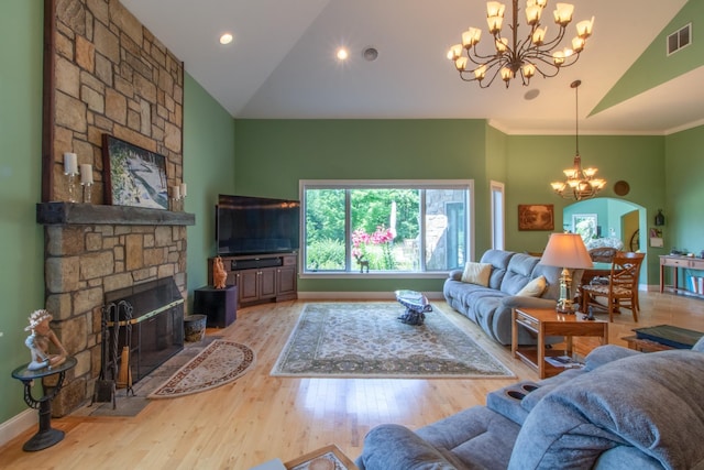 living room featuring crown molding, an inviting chandelier, high vaulted ceiling, a fireplace, and wood-type flooring